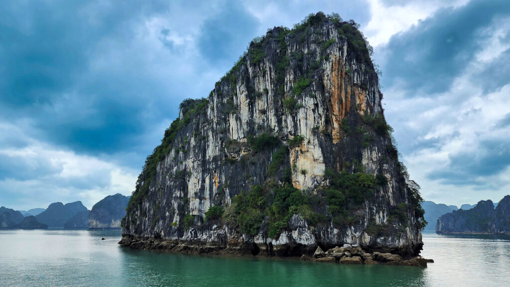 A giant rock sticking out of the waters of Halong Bay, Vietnam.